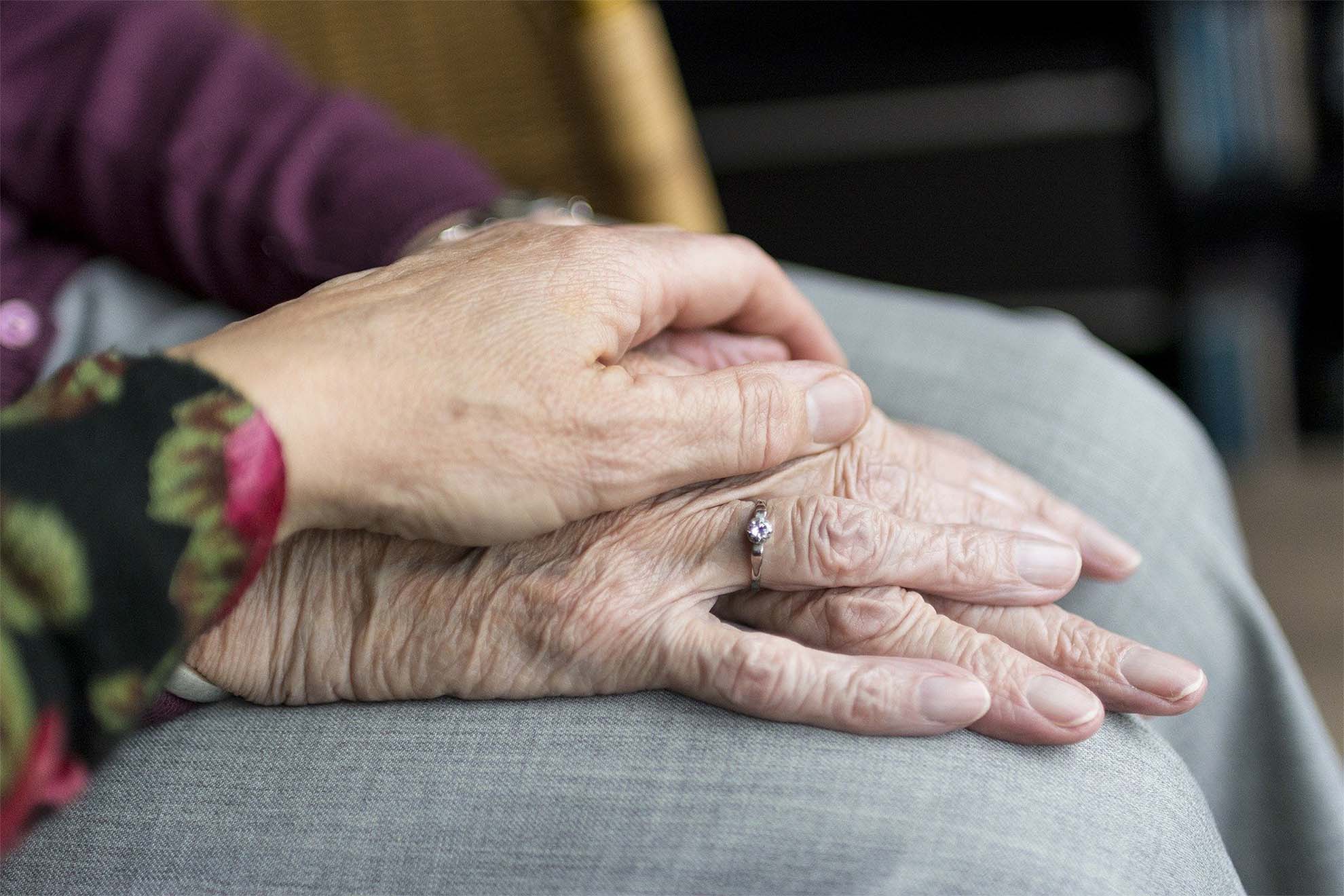 carer holding hands with a resident