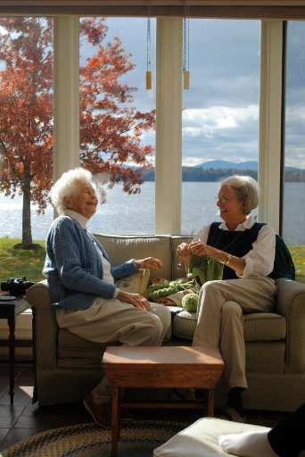 two older ladies in care home sitting room