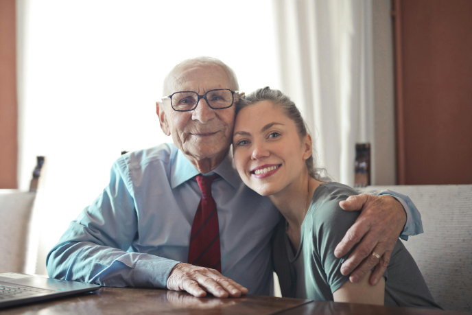 Older man and young woman looking at camera