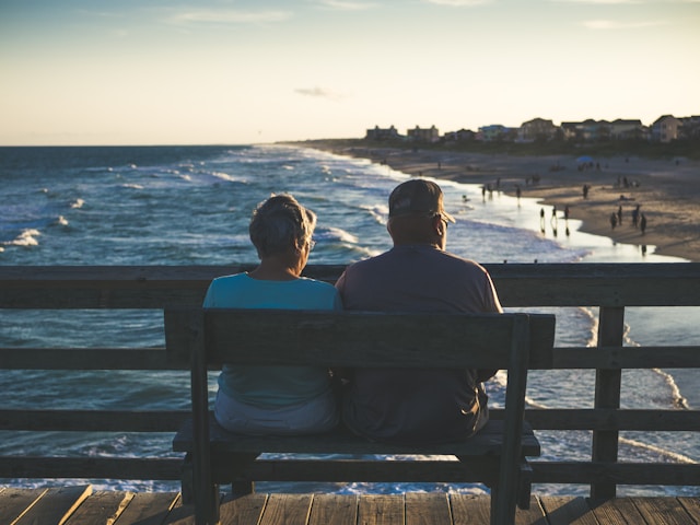 residents sitting on a bench in the sun